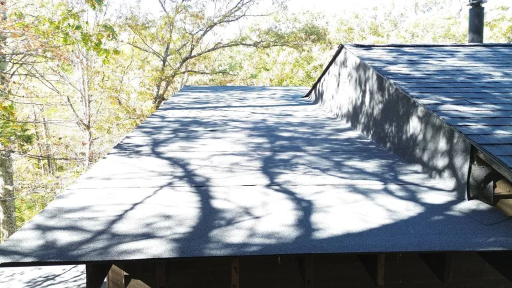 Article illustration of a low-slope roof membrane meeting an asphalt-shingle roof section