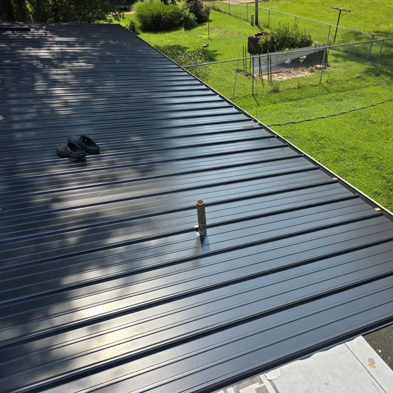 Standing-seam metal roof surface with a flashed roof penetration