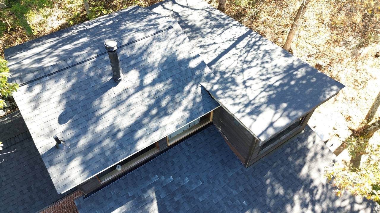 Saint Louis homeowner inspecting roof shingles