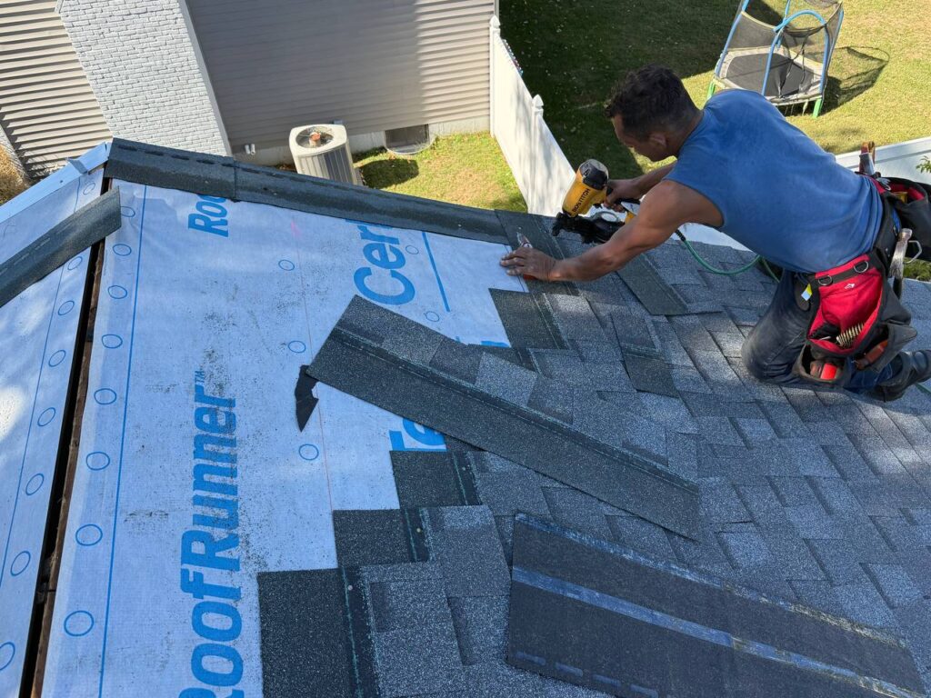 Roofing contractors finishing new roof installation on Missouri home