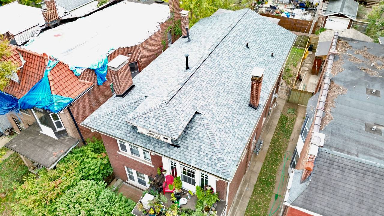 Roofing shingles staged before installation on Saint Louis driveway