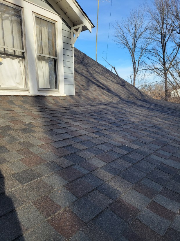 Close-up of shingles during DIY roof maintenance