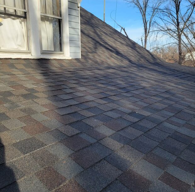 Close-up of shingles during DIY roof maintenance