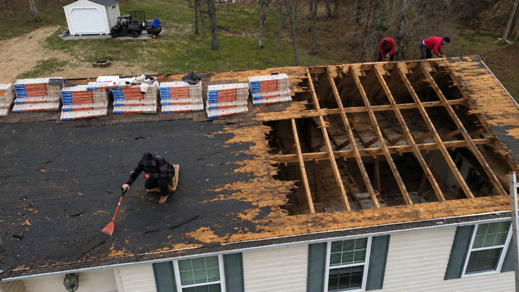 Roof replacement project in Eureka, Missouri with damaged shingles and partial roof tear-off in progress